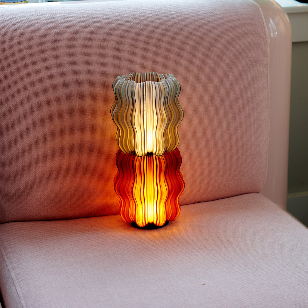 Decorative lamp with wavy design on a pink chair